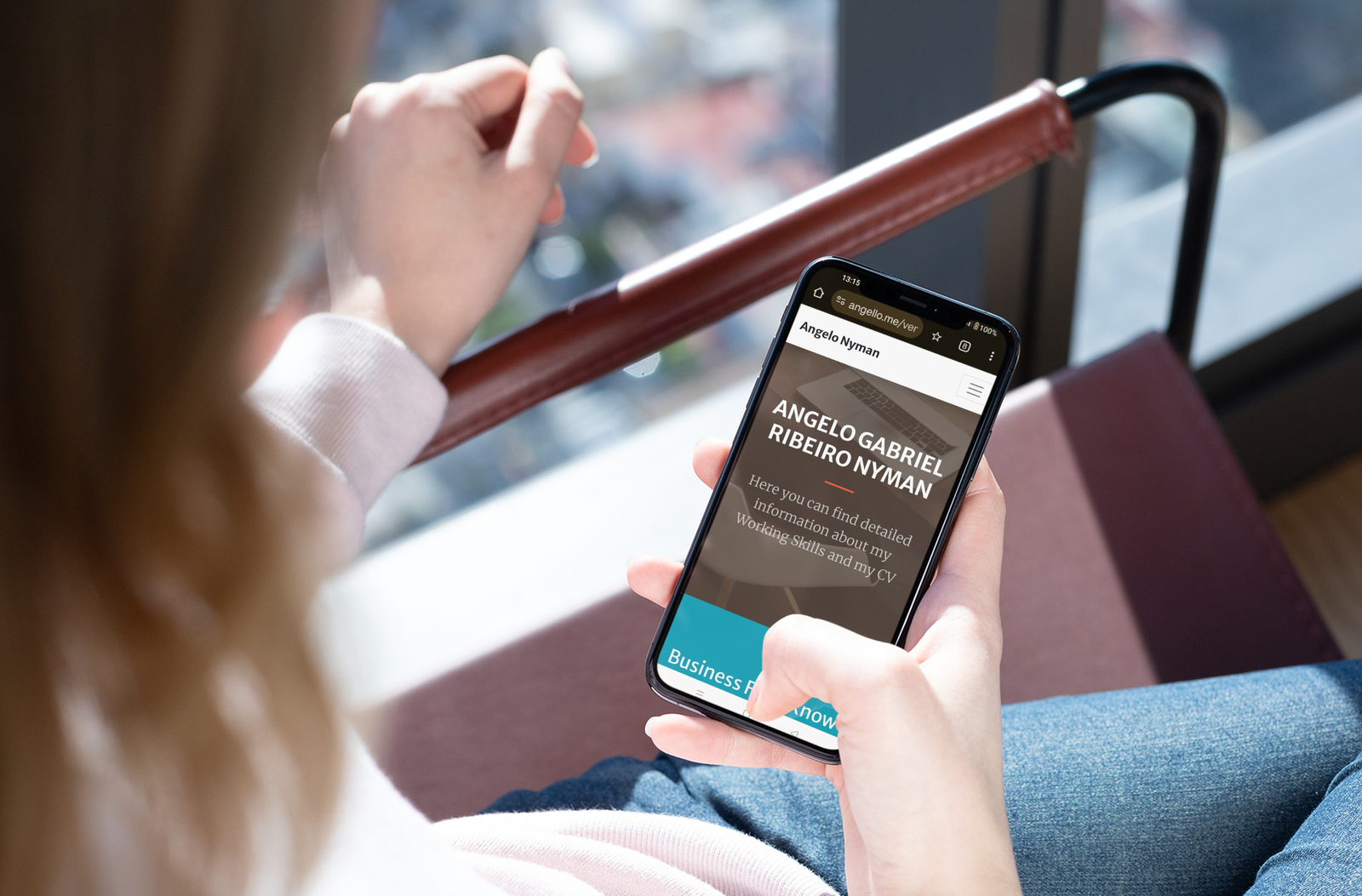 over the shoulder iphone xs mockup of a girl sitting on a minimalist chair 25440